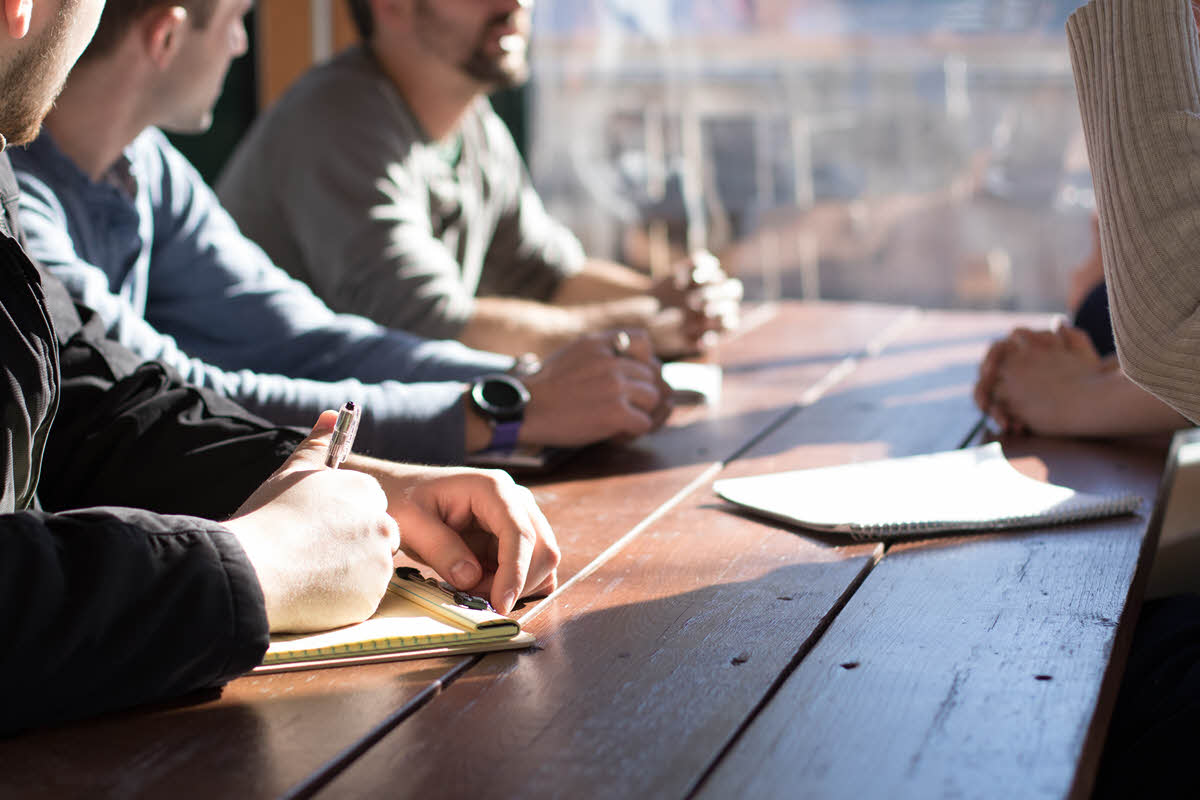 people sitting at a table in a meeting