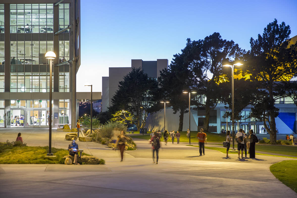 students walking down path by library and Cesar Chavez Student Center