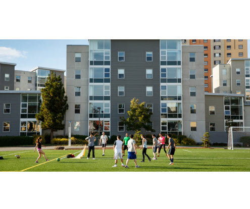 students playing sports on west campus green